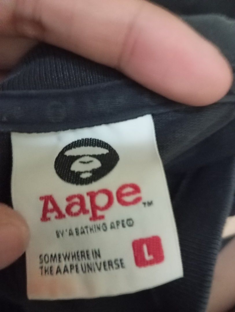 AAPE by A Bathing Ape Black T-shirt (Category: Tshirts & Polo Shirts ) located in Manila. Submitted by kimlee_ (Listing ID 1430207478, Image 3). Description: - AAPE by A Bathing Ape T-shirt - Size: L - Features: - AAPE logo on the front - Target-like graphic with Ape Head logo on the back - "SOMEWHERE IN THE AAPE UNIVERSE" printed on the back.