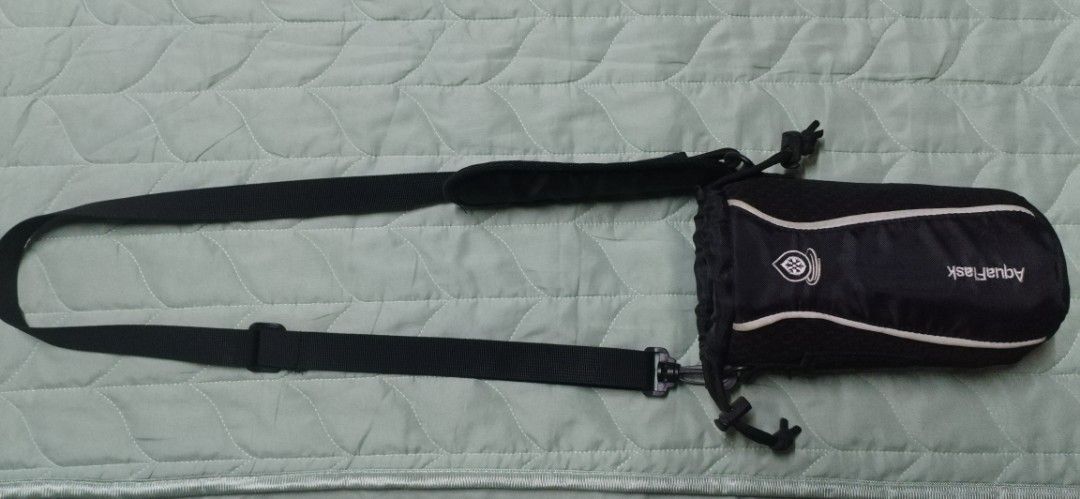 Aquaflask Water Bottle Bag with Strap (Category: Water Bottles & Tumblers) located in Manila. Submitted by patrickdeclutters (Listing ID 1430201634, Image 1). Description: Aquaflask water bottle bag is designed to carry your water bottle comfortably. It features a black design with white accents and an adjustable strap for easy carrying. The bag has a drawstring closure to secure the bottle. It is ideal for outdoor activities, travel, or everyday
