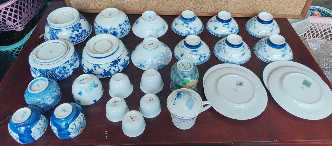 Assorted Ceramic Dinnerware Set (Category: Dinnerware & Cutlery) located in Quezon City. Submitted by fairviewlady11 (Listing ID 1430048211, Image 3). Description: Collection of ceramic dinnerware including bowls, plates, and cups. Features various sizes and designs, with blue and white floral patterns. Includes a covered cup and a decorative green and floral cup. Perfect for serving meals or adding to a collection..