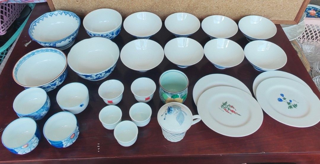 Assorted Ceramic Dinnerware Set (Category: Dinnerware & Cutlery) located in Quezon City. Submitted by fairviewlady11 (Listing ID 1430048211, Image 2). Description: Collection of ceramic dinnerware including bowls, plates, and cups. Features various sizes and designs, with blue and white floral patterns. Includes a covered cup and a decorative green and floral cup. Perfect for serving meals or adding to a collection..