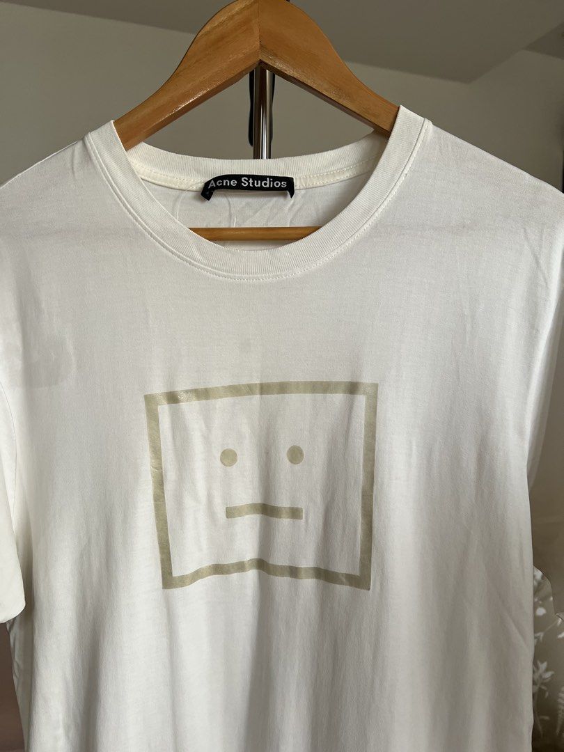 (Authentic) Acne Studios Face T-shirt (Category: Luxury Apparel) located in Cavite. Submitted by kumbin (Listing ID 1430211733, Image 2). Description: Acne Studios Shirt (100% legit) Bought from Good Goods/Boss Idol so we can guarantee the authenticity Dimensions: 19.5 by 28.5 (M on tag) Issue: None Condition: 9.5/10 great +sf Shipping via J&T.