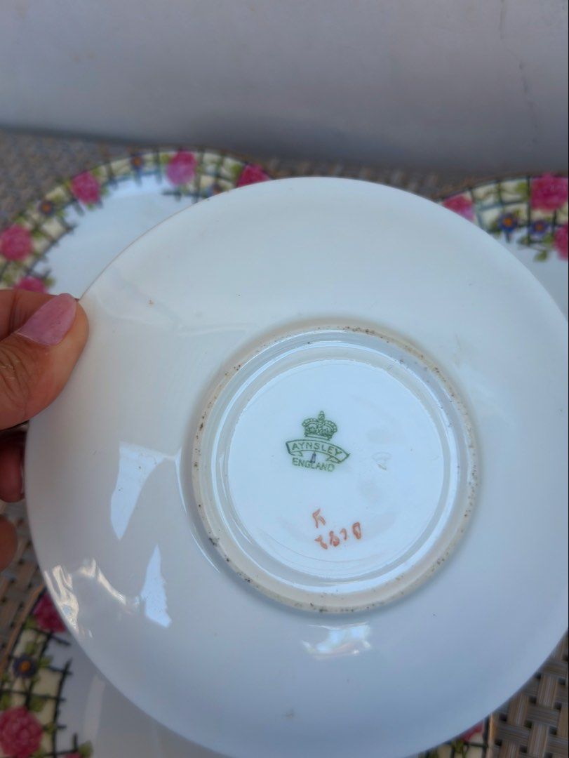 Aynsley England Saucers (Category: Coffee & Tea Tableware) located in Bulacan. Submitted by fancy.surplusera (Listing ID 1430078314, Image 2). Description: Set of four Aynsley England saucers. Features a floral design with pink roses and a gold rim. The saucers have a white base with a decorative border. The Aynsley England mark is visible on the underside of one saucer. A classic and elegant addition to any tea set. Condition: 7/10 Size: 14cm Pr
