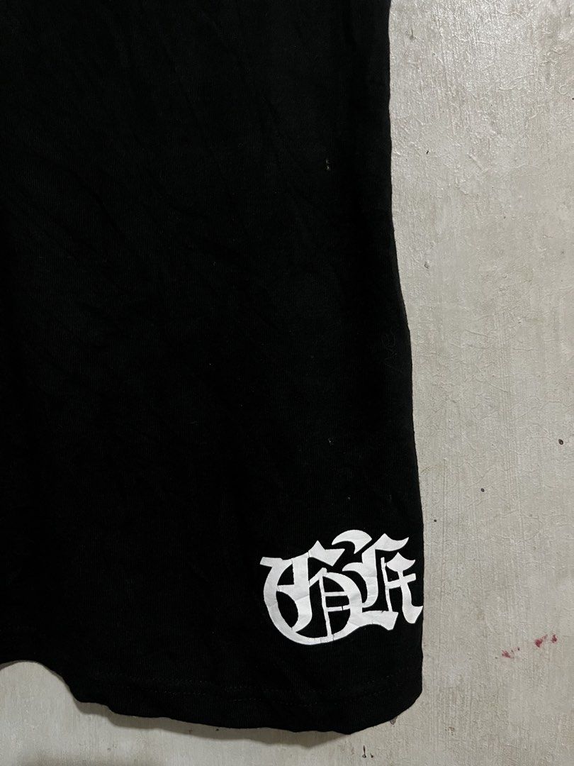 Black Tank Top with Graphic Print (Category: Sleeveless) located in Santa Cruz. Submitted by thriftgane0.2 (Listing ID 1430103782, Image 3). Description: Black tank top with a unique graphic print on the back. Features a sword design with intricate detailing and text. The front has a simple design on the bottom left. Sleeveless design, perfect for casual wear. Made from a comfortable fabric..