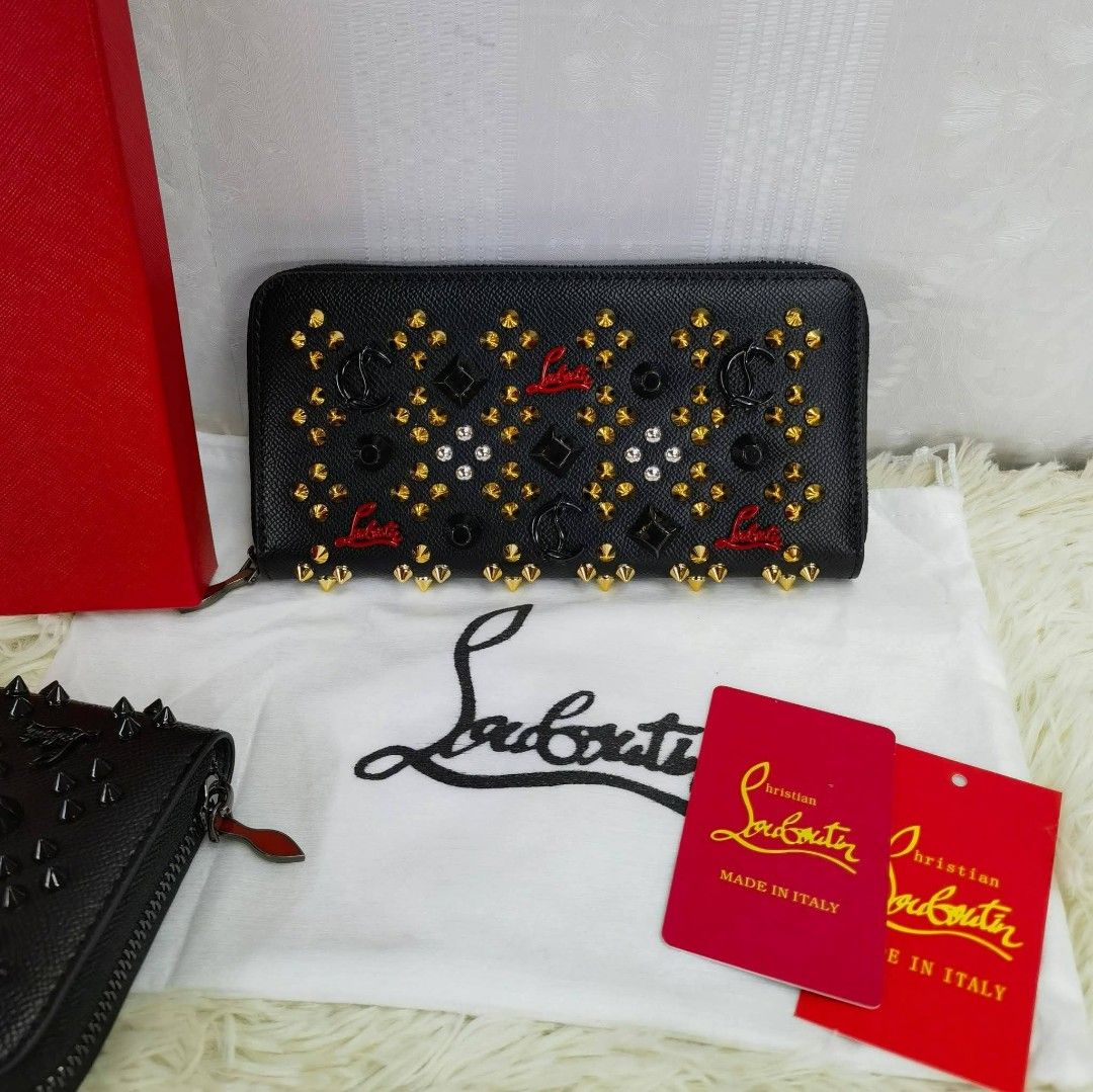 Christian Louboutin Studded Wallet (Category: Luxury Bags & Wallets) located in Manila. Submitted by directsuppliermla (Listing ID 1430061355, Image 2). Description: Christian Louboutin wallet with studded details. Features a zip-around closure and multiple card slots. Comes with a dust bag and tags. Available in black and red colors. Made in Italy..