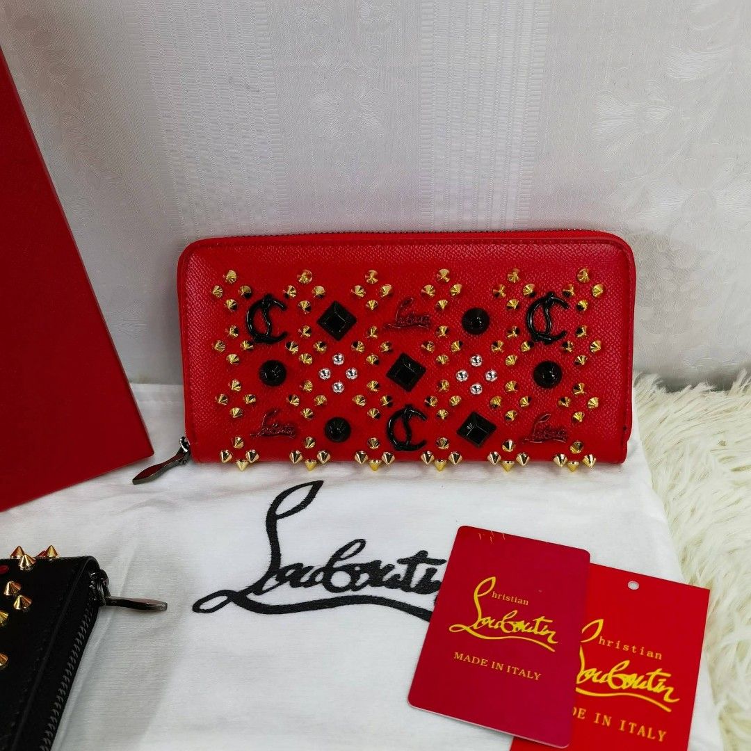 Christian Louboutin Studded Wallet (Category: Luxury Bags & Wallets) located in Manila. Submitted by directsuppliermla (Listing ID 1430061355, Image 3). Description: Christian Louboutin wallet with studded details. Features a zip-around closure and multiple card slots. Comes with a dust bag and tags. Available in black and red colors. Made in Italy..