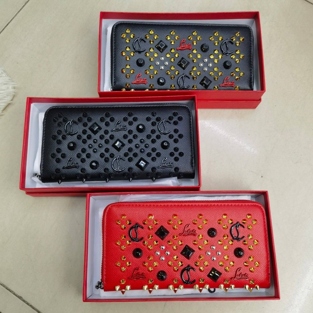 Christian Louboutin Studded Wallet (Category: Luxury Bags & Wallets) located in Manila. Submitted by directsuppliermla (Listing ID 1430061355, Image 1). Description: Christian Louboutin wallet with studded details. Features a zip-around closure and multiple card slots. Comes with a dust bag and tags. Available in black and red colors. Made in Italy..