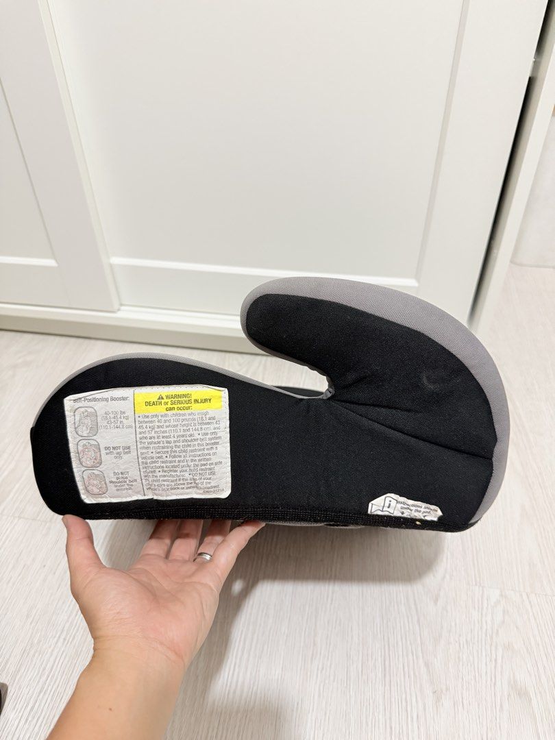 Cosco Booster Car Seat (Category: Car Seats) located in Manila. Submitted by eiram25 (Listing ID 1430059438, Image 3). Description: Cosco booster car seat. Features a gray seat with black accents. The Cosco logo is visible on the front. The bottom of the seat has a textured black surface. Includes safety information labels. Designed for children within a specific weight and height range..