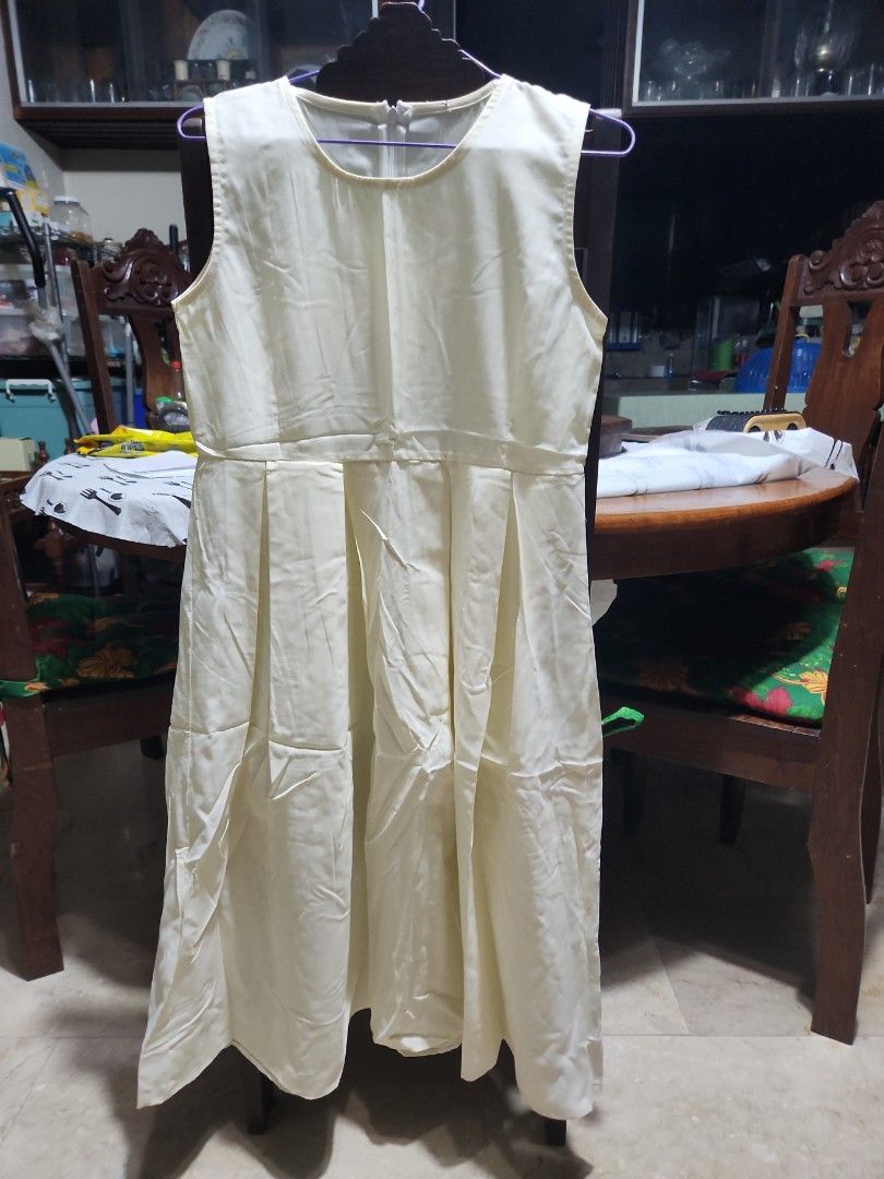 Cream-colored Sleeveless Dress (Category: Dresses) located in Makati City. Submitted by fairytale8888 (Listing ID 1430165285, Image 1). Description: Cream-colored dress features a sleeveless design and a pleated skirt. It has a round neckline and a fitted waist. It has a simple, elegant design, perfect for casual or semi-formal occasions. Tags removed .