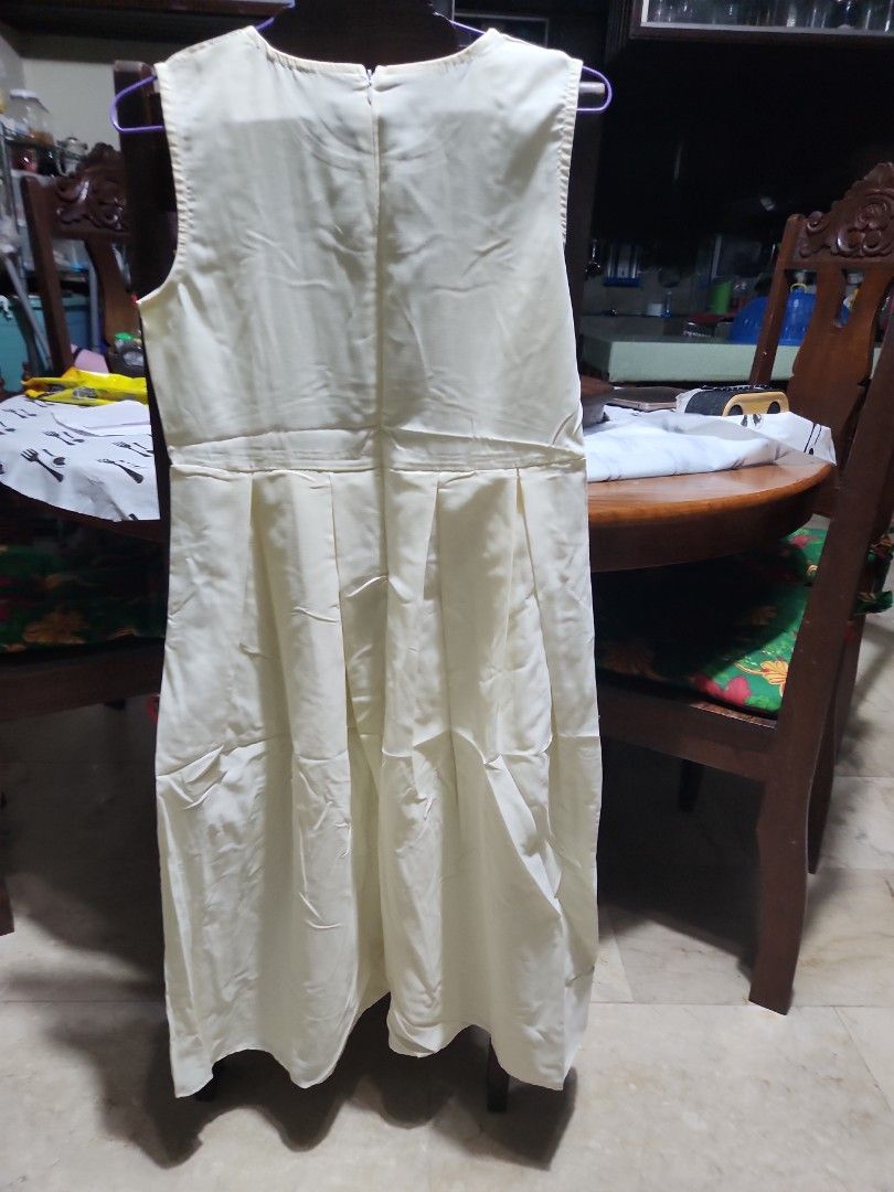 Cream-colored Sleeveless Dress (Category: Dresses) located in Makati City. Submitted by fairytale8888 (Listing ID 1430165285, Image 2). Description: Cream-colored dress features a sleeveless design and a pleated skirt. It has a round neckline and a fitted waist. It has a simple, elegant design, perfect for casual or semi-formal occasions. Tags removed .