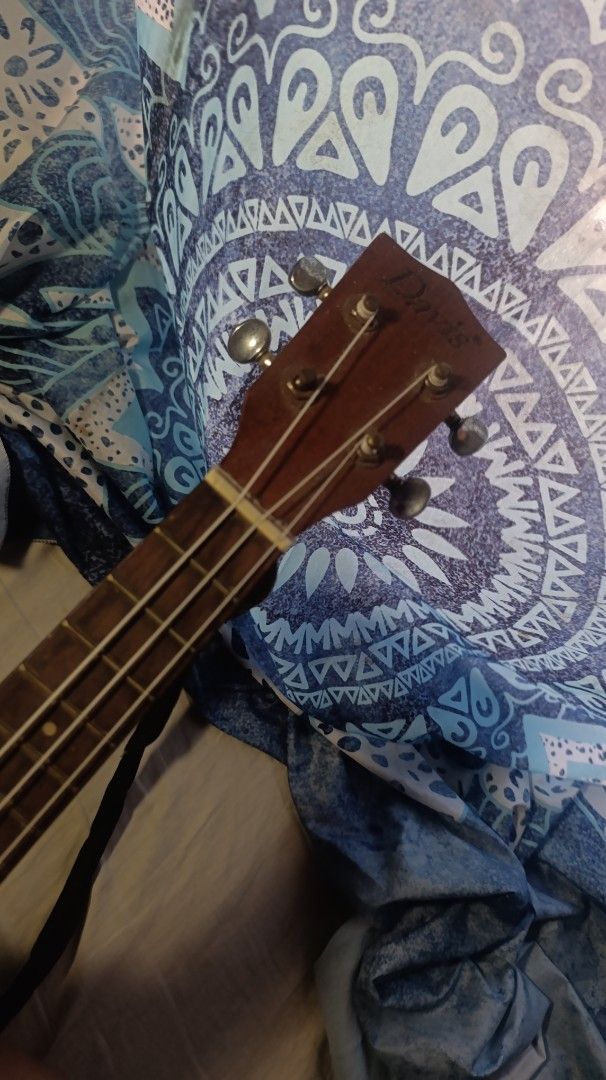 Davis Concert Soprano Ukulele (Category: Musical Instruments) located in Roxas City. Submitted by barbiehues (Listing ID 1430161688, Image 2). Description: Davis ukulele. It has a dark brown body with a yellow trim. The headstock has the Davis logo. It has a built-in preamp with volume and tone controls. The ukulele has four strings and frets. The body has a sound hole..