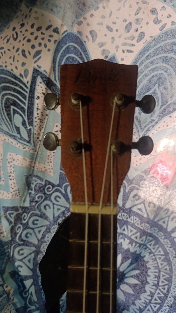 Davis Concert Soprano Ukulele (Category: Musical Instruments) located in Roxas City. Submitted by barbiehues (Listing ID 1430161688, Image 3). Description: Davis ukulele. It has a dark brown body with a yellow trim. The headstock has the Davis logo. It has a built-in preamp with volume and tone controls. The ukulele has four strings and frets. The body has a sound hole..