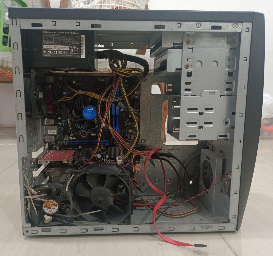 Desktop Computer Case (Category: Desktops) located in Quezon City. Submitted by glaclac (Listing ID 1430128268, Image 2). Description: Desktop computer case. It has a black front panel with several drive bays and a power button. The case includes a power supply, motherboard, and various internal components. It has multiple ports at the back. It does not have a hard drive..
