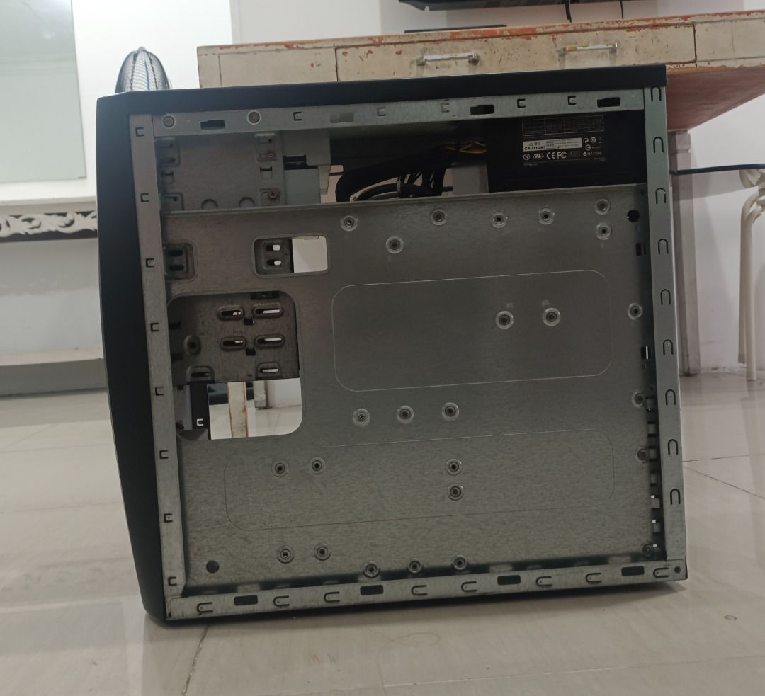Desktop Computer Case (Category: Desktops) located in Quezon City. Submitted by glaclac (Listing ID 1430128268, Image 3). Description: Desktop computer case. It has a black front panel with several drive bays and a power button. The case includes a power supply, motherboard, and various internal components. It has multiple ports at the back. It does not have a hard drive..