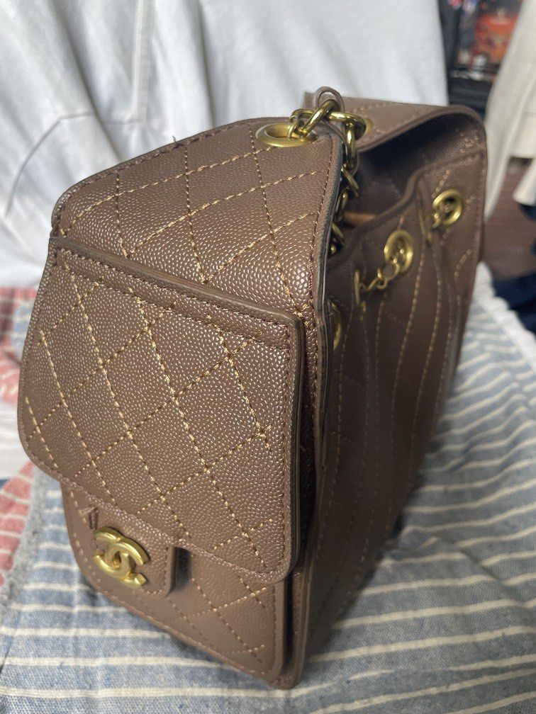 Drawstring bag (Category: Shoulder Bags) located in Singapore. Submitted by Jassslin72 (Listing ID 1428894669, Image 3). Description: Like new milk tea colour drawstring bag. A little chip on the side logo. Black shoulder bag is brand new and selling at $88.