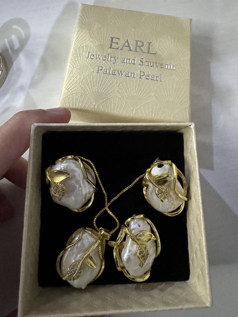 EARL Palawan Pearl Jewelry Set (Category: Necklaces) located in Malabon City. Submitted by jessibells (Listing ID 1430200476, Image 3). Description: Elegant jewelry set from EARL featuring Palawan pearls. The set includes a necklace and a pair of earrings. The pearls are set in gold-colored frames with leaf accents. The set comes in its original box. A beautiful and unique accessory for any occasion..