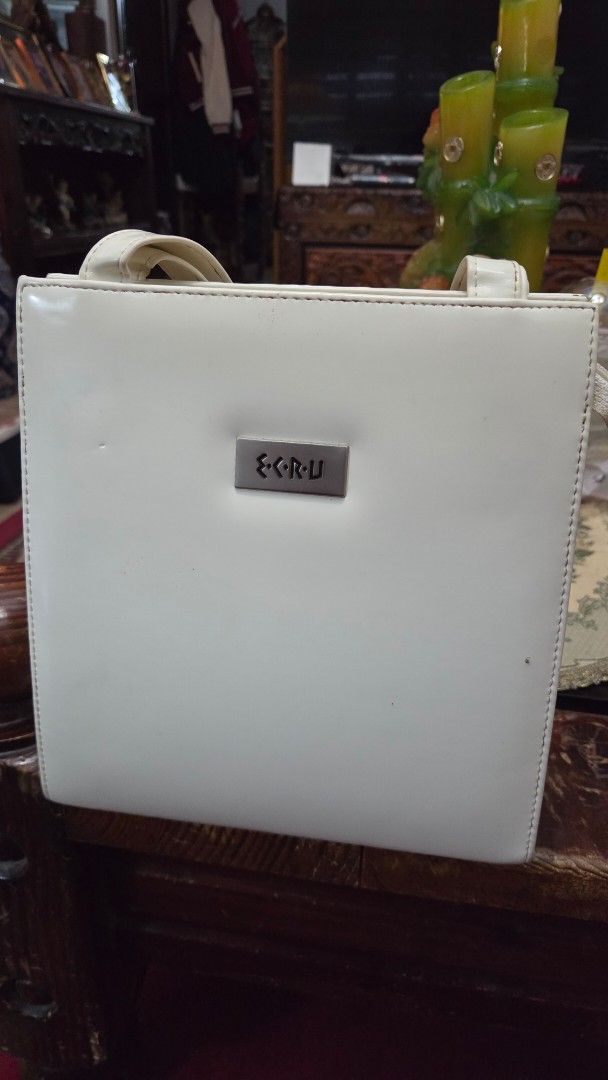 ECRU White Handbag For Sale (Category: Luxury Bags & Wallets) located in Paranaque City. Submitted by nics_11 (Listing ID 1430133573, Image 1). Description: Hi everyone! Selling here my Mom's White handbag with a rectangular shape. Features a small metal plate with the brand name "ECRU". Includes a handle for carrying. The bag has a glossy finish. rfs: Decluttering bags for sale Feel free to pm to inquire and thank you for checking my ad! 🤗💙.