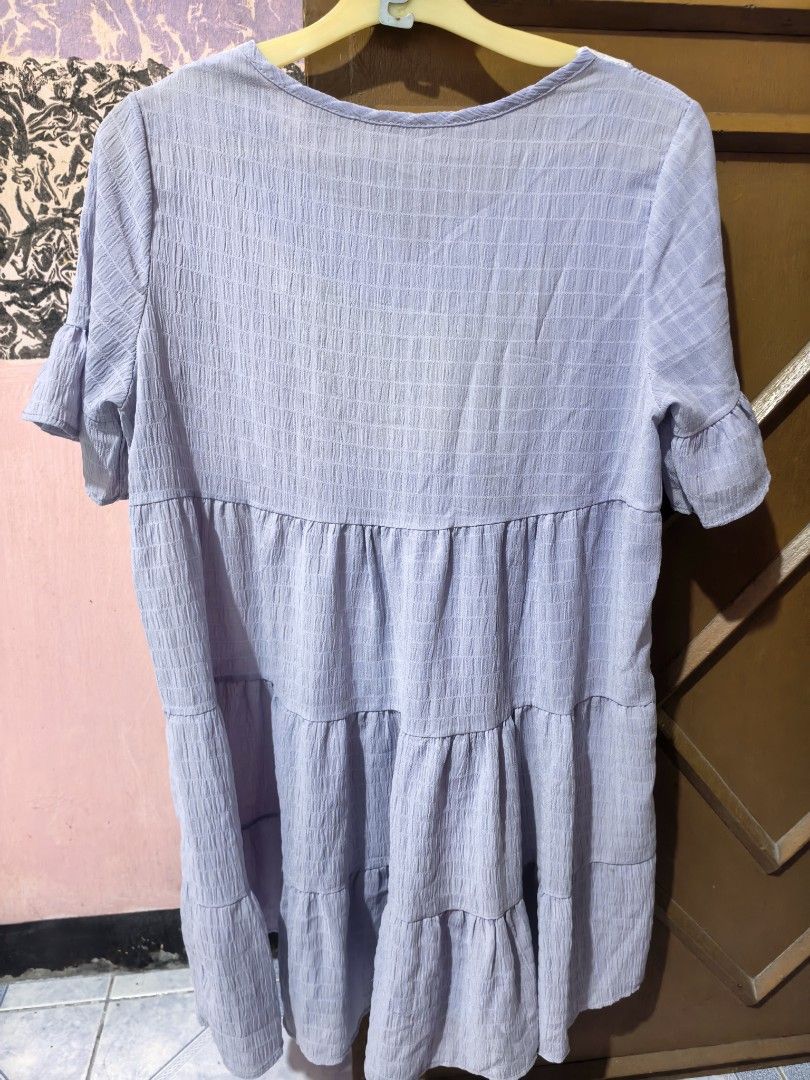 Embroidered Tiered Dress (Category: Dresses) located in Dinalupihan. Submitted by colinnoceda (Listing ID 1430080659, Image 2). Description: Dress features a tiered design with short, ruffled sleeves. It has an embroidered detail on the front. The dress is a light purple color. It has a V-neckline. The back of the dress is plain. 💜🪻.