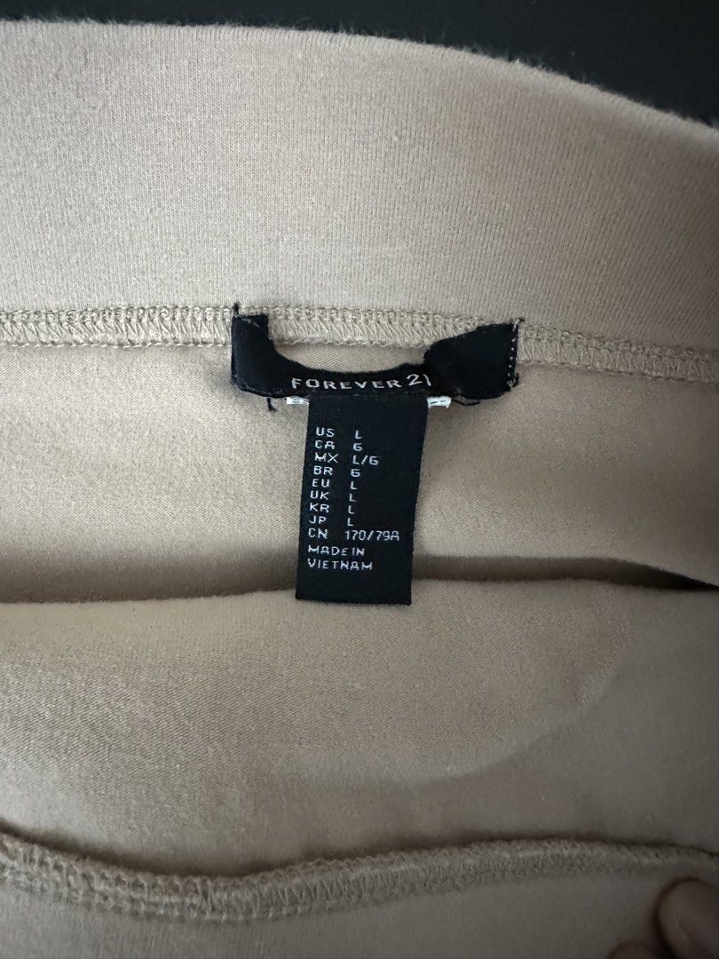 Forever 21 Mini Skirt (Category: Skirts) located in Muntinlupa City. Submitted by rantila (Listing ID 1430086520, Image 2). Description: Listing features a mini skirt from Forever 21. It is available in a dark purple and a beige color. The skirt is a size L. Made in Vietnam. The skirt has an elastic waistband..