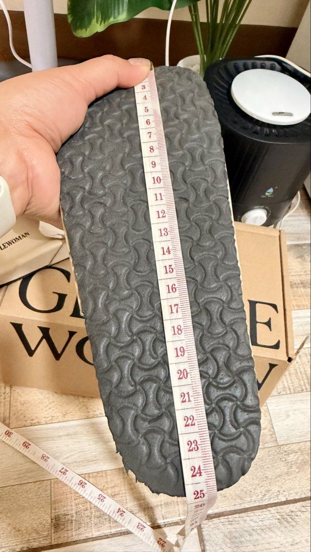 Gentlewoman Slides (Category: Slippers and slides) located in Manila. Submitted by authenticprelovedmnls (Listing ID 1430067239, Image 3). Description: Cream-colored slides from Gentlewoman. Features the brand name in black on the strap. The slides are placed on top of a Gentlewoman box. The footbed is a light cream color with the brand name printed on it. The slides appear to be new and unused. With box ..