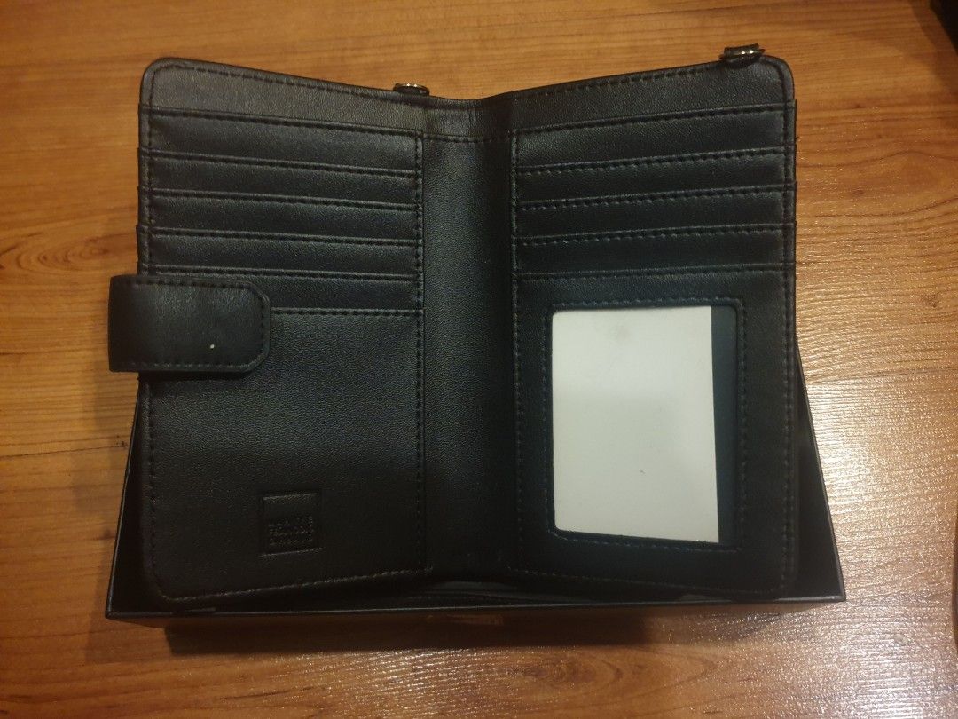 Girbaud Black Leather Sling Wallet (Category: Wallets & Card holders) located in Quezon City. Submitted by aredattic (Listing ID 1430159703, Image 2). Description: Black wallet by Girbaud. It features multiple card slots, a clear ID window, and a snap closure. Includes a detachable bag strap and comes with its original box. Flaw: peeling leather Rfs: decluttering old bags.