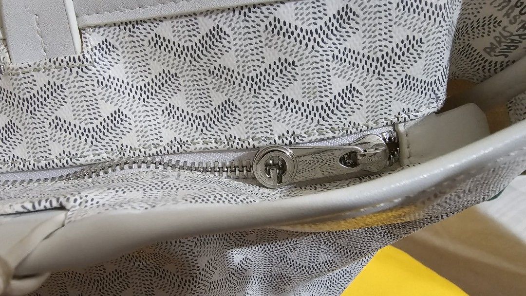 Goyard St. Louis Tote Bag White (Category: Luxury Bags & Wallets) located in Caloocan City. Submitted by marie_0812 (Listing ID 1430129331, Image 2). Description: Features a zip closure and a spacious interior. Includes a dust bag. The bag has the signature Goyardine pattern. Made in France. The bag has white leather handles and trim. The interior has a small pocket..