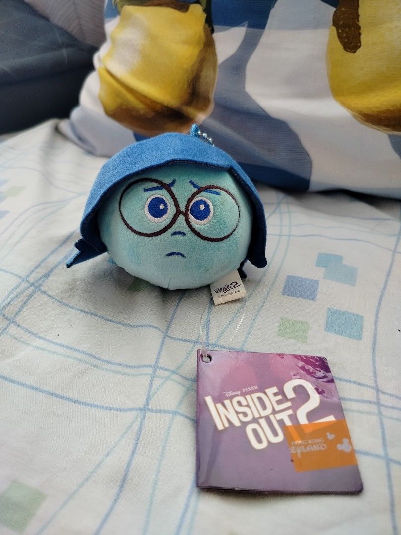 Inside Out 2 Sadness Plush Keychain (Category: Plushies & Soft Toys) located in Manila. Submitted by prelovedbagsbykei (Listing ID 1430056553, Image 1). Description: Includes the original tag, HKD 99 from HongKong Disneyland MOP: GCASH MOD: J&T NEGOTIABLE.