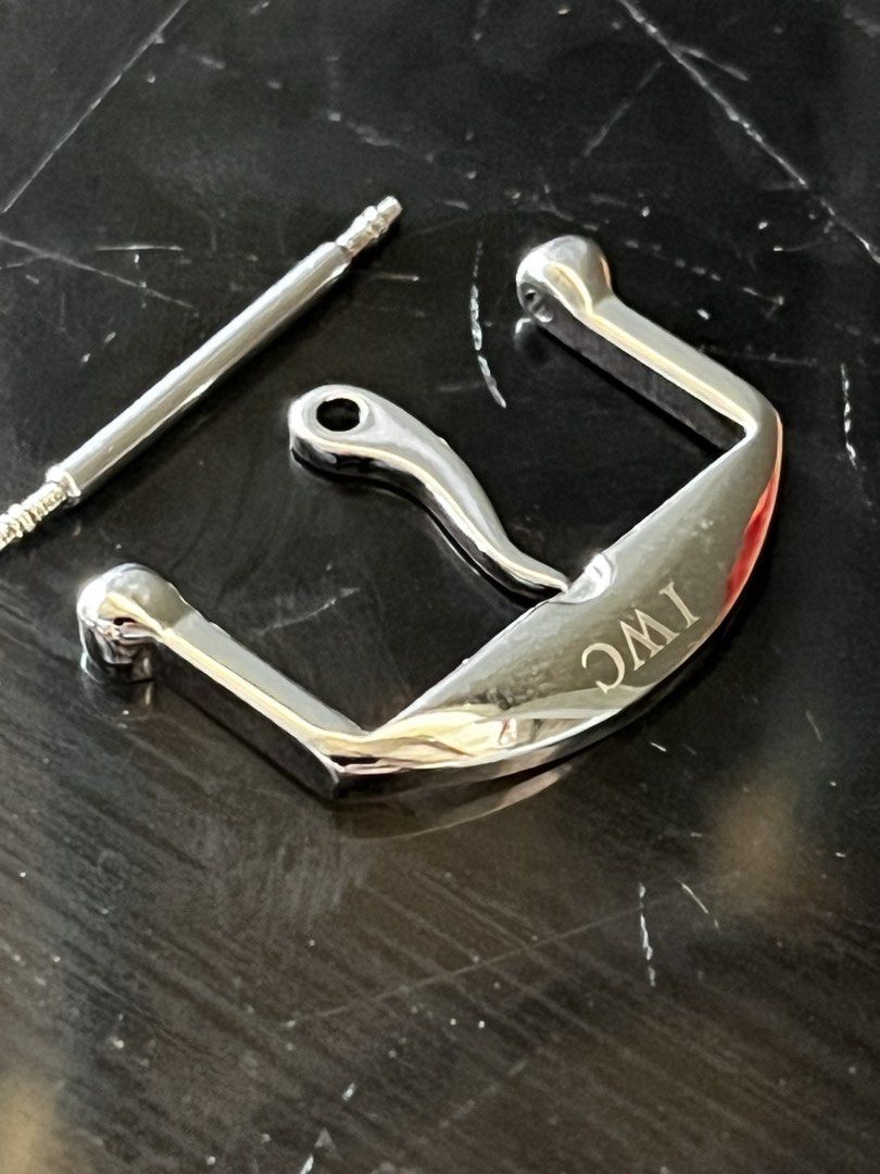 IWC Watch Buckle (Category: Luxury Watches) located in Manila. Submitted by boldtree_947e32 (Listing ID 1430087565, Image 1). Description: Genuine IWC watch buckle. Includes the buckle itself, a spring bar, and a clasp. The buckle is silver in color and features the IWC logo. The design is sleek and modern. 18mm lug width from ebay.