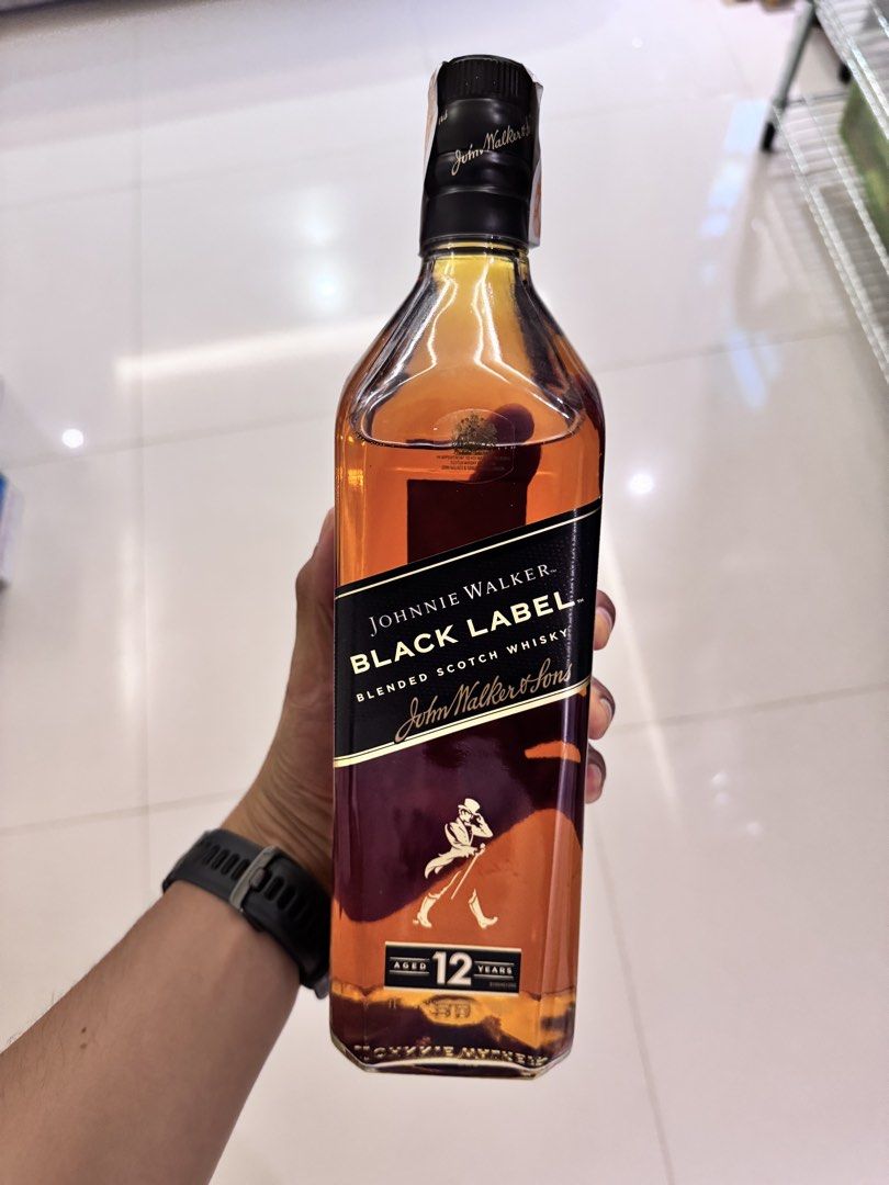 Johnnie Walker Black Label 12 Year Old (Category: Beverages) located in Manila. Submitted by rivera22ma79392 (Listing ID 1430173116, Image 2). Description: Johnnie Walker Black Label 12 Year Old Blended Scotch Whisky. Several bottles are available. The label features the iconic Johnnie Walker Striding Man. Each bottle has a black label with gold lettering and a distinctive bottle shape. The age statement '12' is prominently displayed. 1L/bottle P