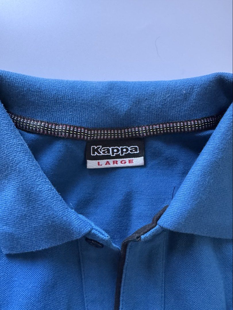 Kappa Soccer Polo Shirt - Large (Category: Tshirts & Polo Shirts ) located in Quezon City. Submitted by poleng08 (Listing ID 1430145135, Image 2). Description: Blue Kappa polo shirt with black accents. Features a Kappa Soccer patch on the chest and Kappa logo on the sleeve. The shirt has a collared neckline and a three-button placket. The size is Large. 100% Authentic, bought from Singapore.