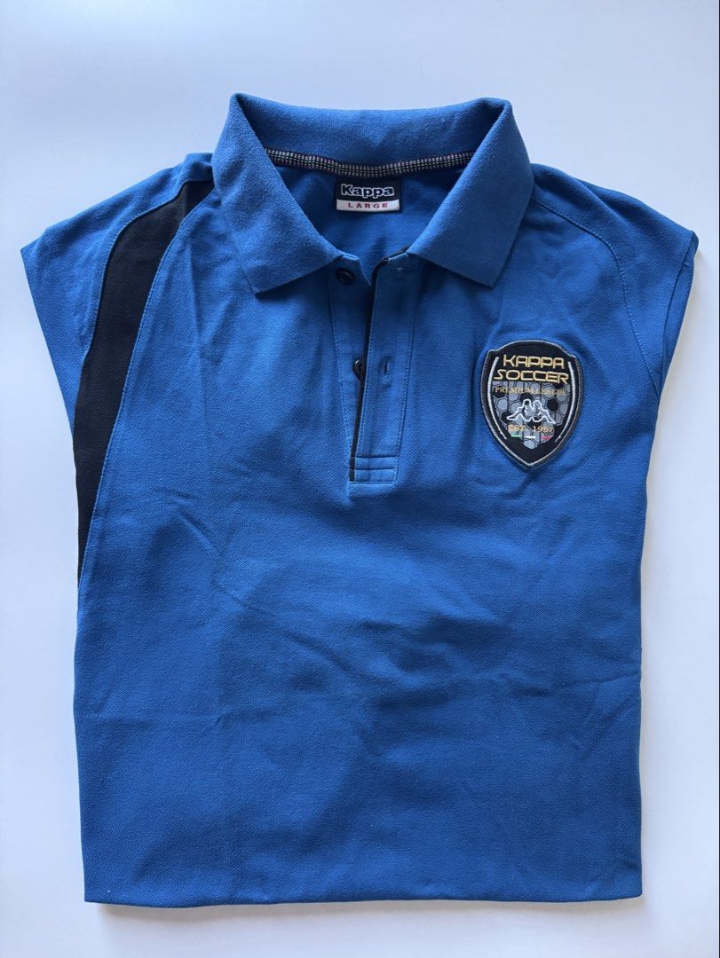 Kappa Soccer Polo Shirt - Large (Category: Tshirts & Polo Shirts ) located in Quezon City. Submitted by poleng08 (Listing ID 1430145135, Image 1). Description: Blue Kappa polo shirt with black accents. Features a Kappa Soccer patch on the chest and Kappa logo on the sleeve. The shirt has a collared neckline and a three-button placket. The size is Large. 100% Authentic, bought from Singapore.