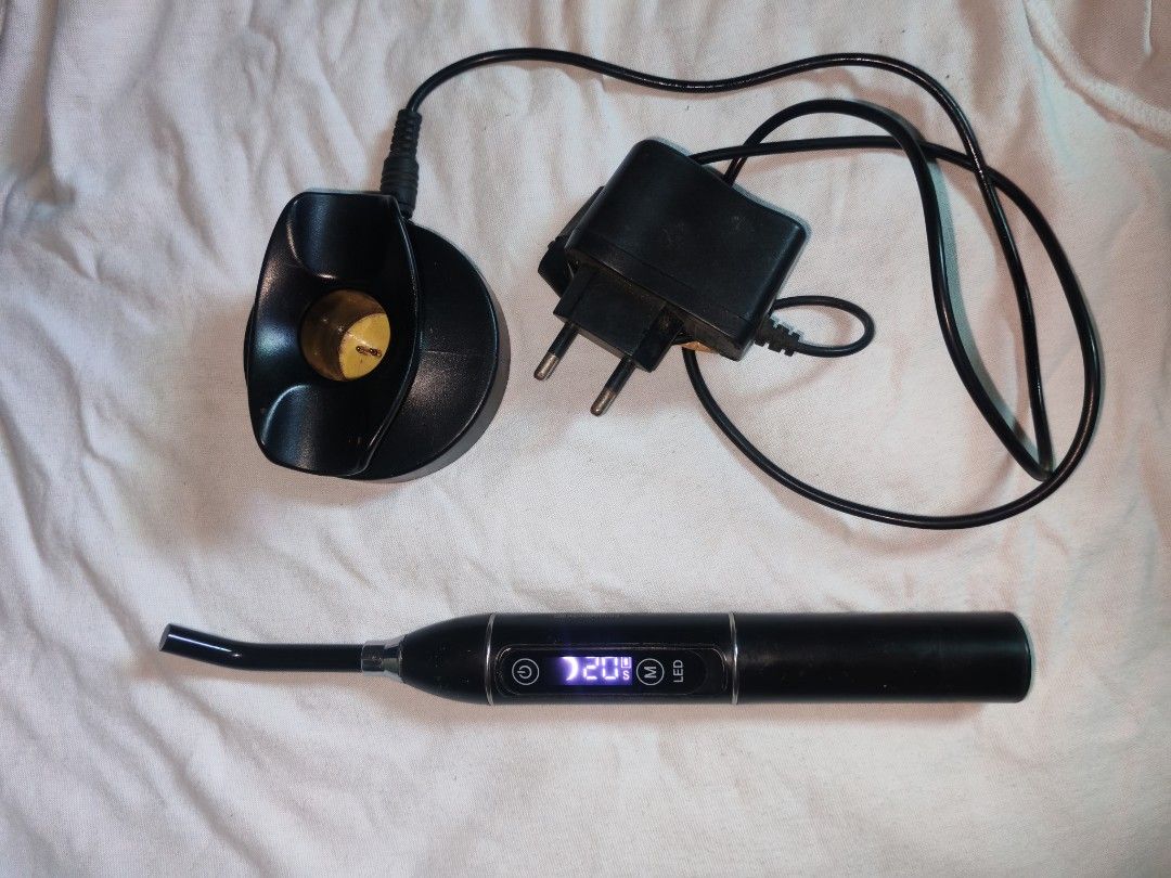 LED Curing Light (Category: Medical Supplies & Tools) located in Quezon City. Submitted by rowem (Listing ID 1429991360, Image 2). Description: In a very good condition.. Black LED curing light. It has an angled tip and two buttons labeled 'O' and 'M LED'. It is designed for dental or cosmetic use..