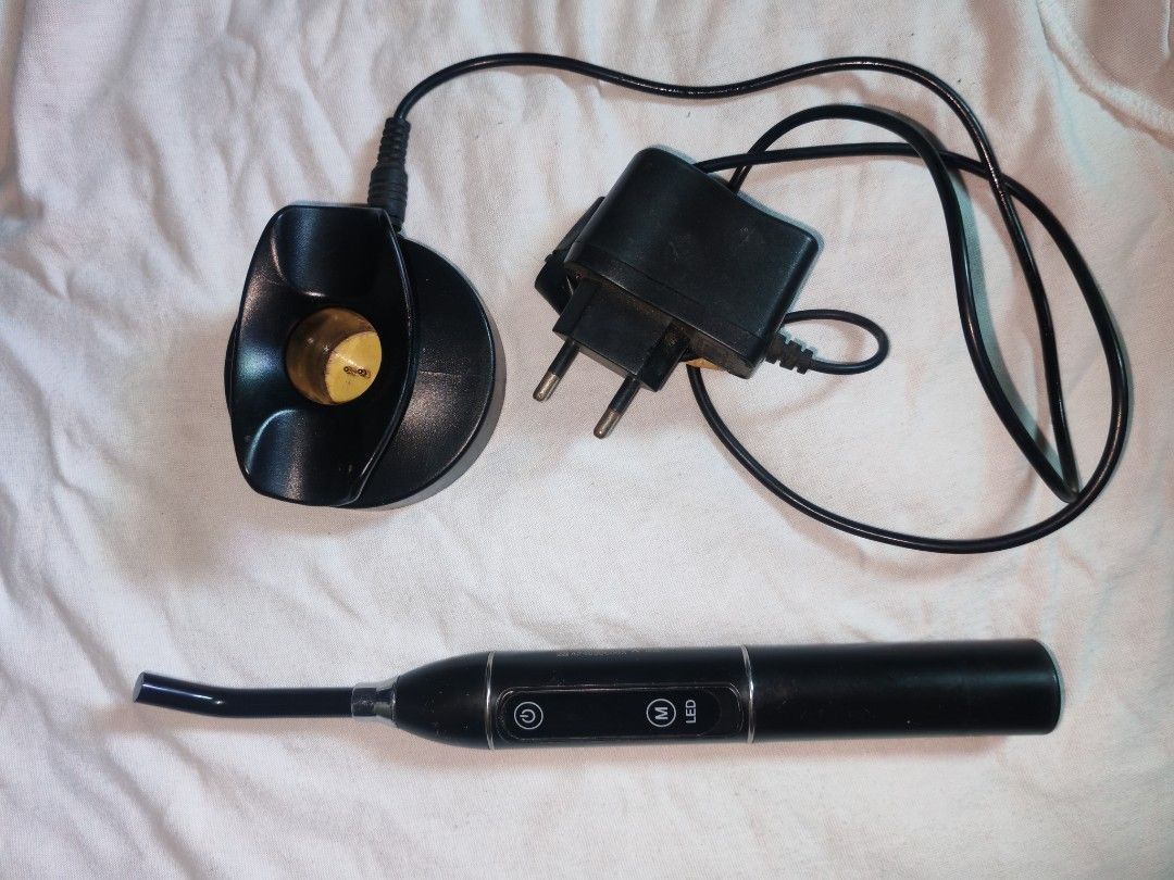 LED Curing Light (Category: Medical Supplies & Tools) located in Quezon City. Submitted by rowem (Listing ID 1429991360, Image 3). Description: In a very good condition.. Black LED curing light. It has an angled tip and two buttons labeled 'O' and 'M LED'. It is designed for dental or cosmetic use..