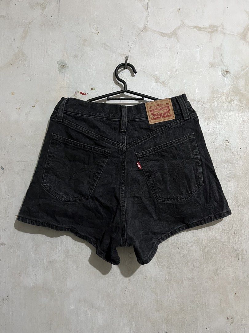 Levi's High Waisted Mom Shorts - Black (Category: Shorts) located in Santa Cruz. Submitted by thriftgane0.2 (Listing ID 1430103606, Image 1). Description: Levi's high-waisted mom shorts in black. Features a classic five-pocket design with a button and zipper closure. The shorts have the Levi's red tab on the back pocket. Size 27. Made of denim material..