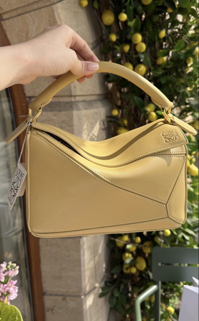Loewe Puzzle featherlight (Category: Luxury Bags & Wallets) located in Silang. Submitted by girlyouneedthis (Listing ID 1430127933, Image 1). Description: Flash sale today only. Loewe puzzle featherlight in this beautiful butter yellow color. Genuine leather, coded, comes with dustbag and sling. No returns, No exchange, No refunds..