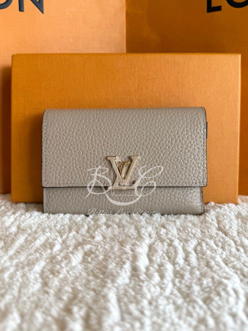 Louis Vuitton Capucines Compact Wallet Galet Taurillon (Category: Luxury Bags & Wallets) located in Paranaque City. Submitted by belles_lux_closet (Listing ID 1430149977, Image 2). Description: AUTHENTIC CAPUCINES COMPACT WALLET GHW IN GALET TAURILLON LEATHER (Like New, Microchipped & Full Set) ✅ 100% Guaranteed Authentic ✅ Microchipped ✅ Excellent Condition, Rank A-SA ✅ FULL SET! Comes with dust bag and box! ✅ Legit seller Retails at ~Php 65,000
