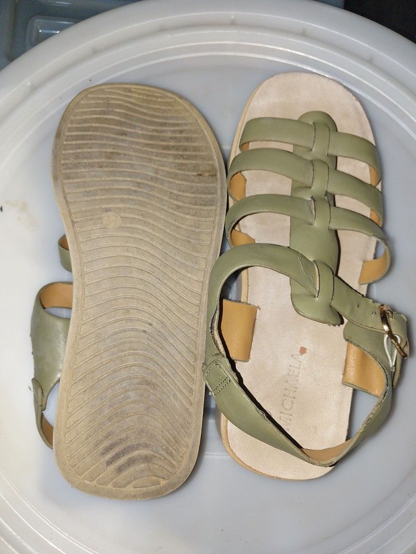 Michaela Green Sandals (Category: Flats & Sandals) located in Manila. Submitted by busy_market (Listing ID 1430131911, Image 2). Description: These sandals feature a green leather upper with a strappy design. They have a buckle closure for a secure fit. The sole is a light brown color. The brand name "Michalia" is visible on the insole..