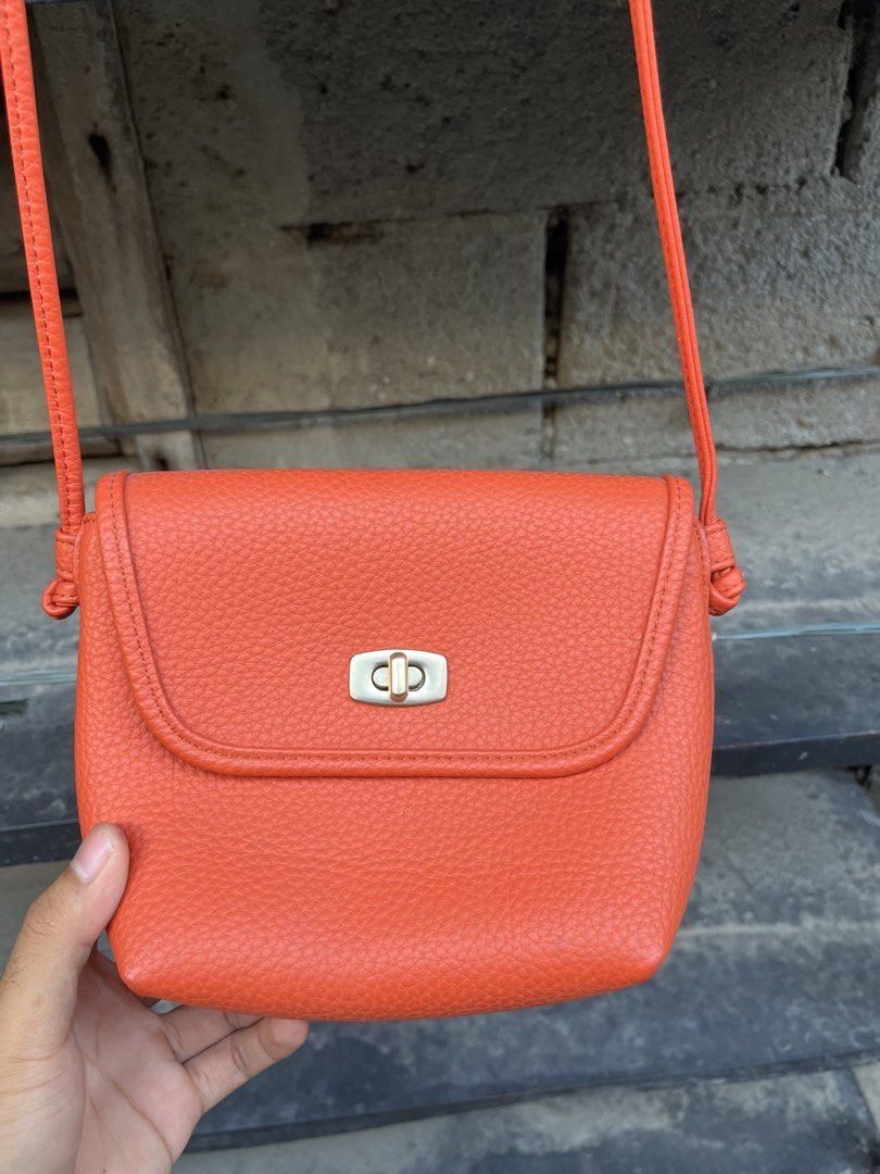 Orange Crossbody Bag with Shoulder Strap (Category: Cross-body Bags) located in Sultan Kudarat. Submitted by c_jay28 (Listing ID 1430071242, Image 2). Description: Orange crossbody bag features a textured exterior and a secure clasp closure. It has a long shoulder strap for easy carrying. Inside, there are multiple compartments for organizing your essentials, including card slots..