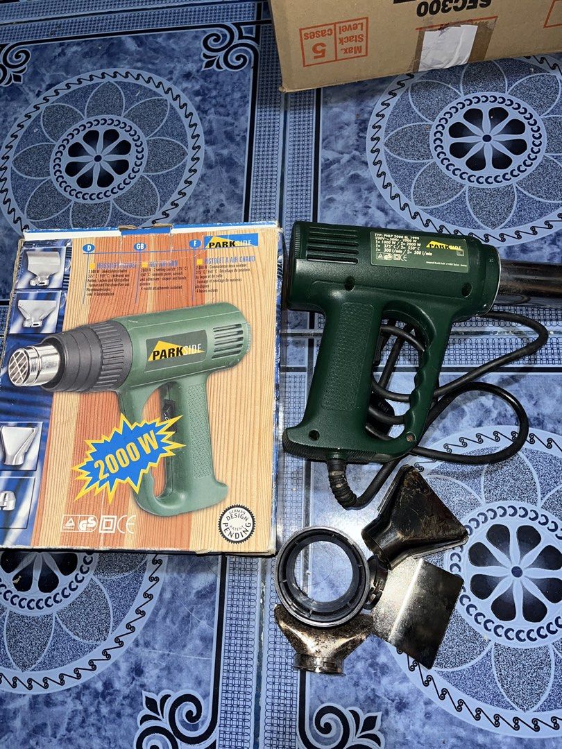 Parkside 2000W Heat Gun with Accessories (Category: Construction Tools & Equipment) located in Paombong. Submitted by sweetdeals0181656 (Listing ID 1430122078, Image 1). Description: Parkside heat gun with multiple attachments. It has a 2000W power output. Includes the original box and user manual. The heat gun has a green body and a black power cord. Several nozzle attachments are included. The model number is PHLP 2000..