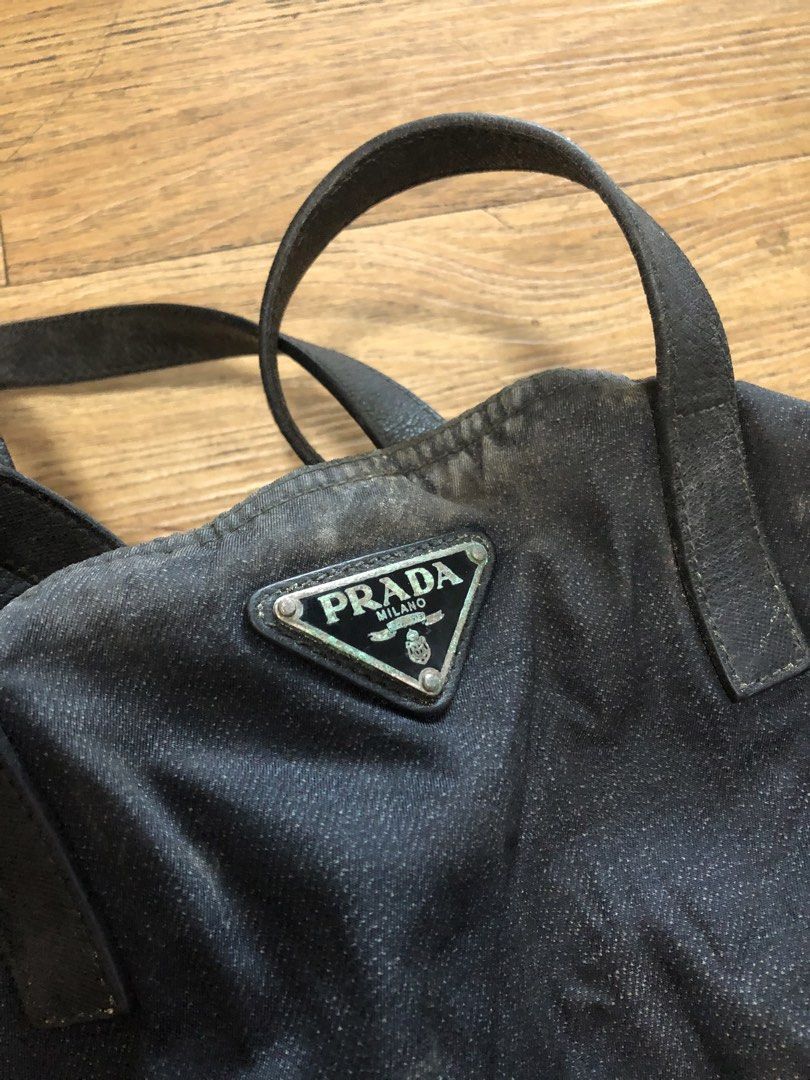 preloved prada denim nylon open tote (Category: Luxury Bags & Wallets) located in Mandaluyong City. Submitted by polopatrick (Listing ID 1430097434, Image 2). Description: purchased from the UK some years ago. damage due to prolonged improper storage, hence the visible oxidation. needs professional cleaning. guaranteed authentic, with complete inclusions. there are also stains on the dust bag & og paperbag. can do meetups around mandaluyong area 
