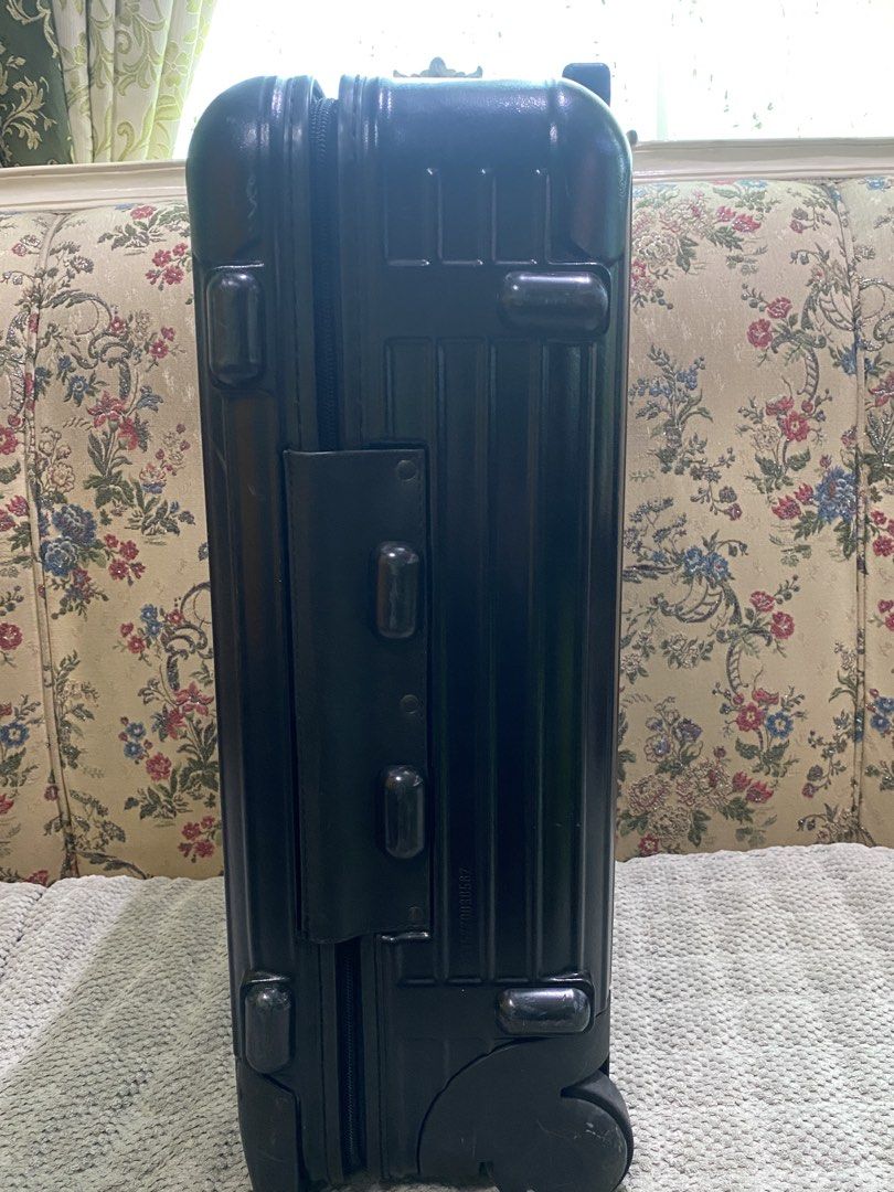 Rimowa Cabin Suitcase Black (Category: Luggage) located in Malolos. Submitted by yamaguchionline (Listing ID 1430042240, Image 3). Description: Black Rimowa cabin suitcase with a retractable handle and wheels. Features a combination lock and the Rimowa logo. The interior has a mesh divider and straps to secure belongings. Made in Germany. Includes a zipper closure and a handle on top. The suitcase has a serial number..