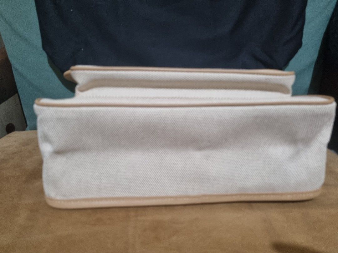 Saint Laurent Canvas Shoulder Bag (Category: Luxury Bags & Wallets) located in Quezon City. Submitted by shopewisely (Listing ID 1430046916, Image 2). Description: Saint Laurent shoulder bag features a beige canvas body with tan leather trim. It has a gold-tone chain strap and a magnetic snap closure. The interior is lined with a matching beige fabric. The bag has the YSL logo on the front..
