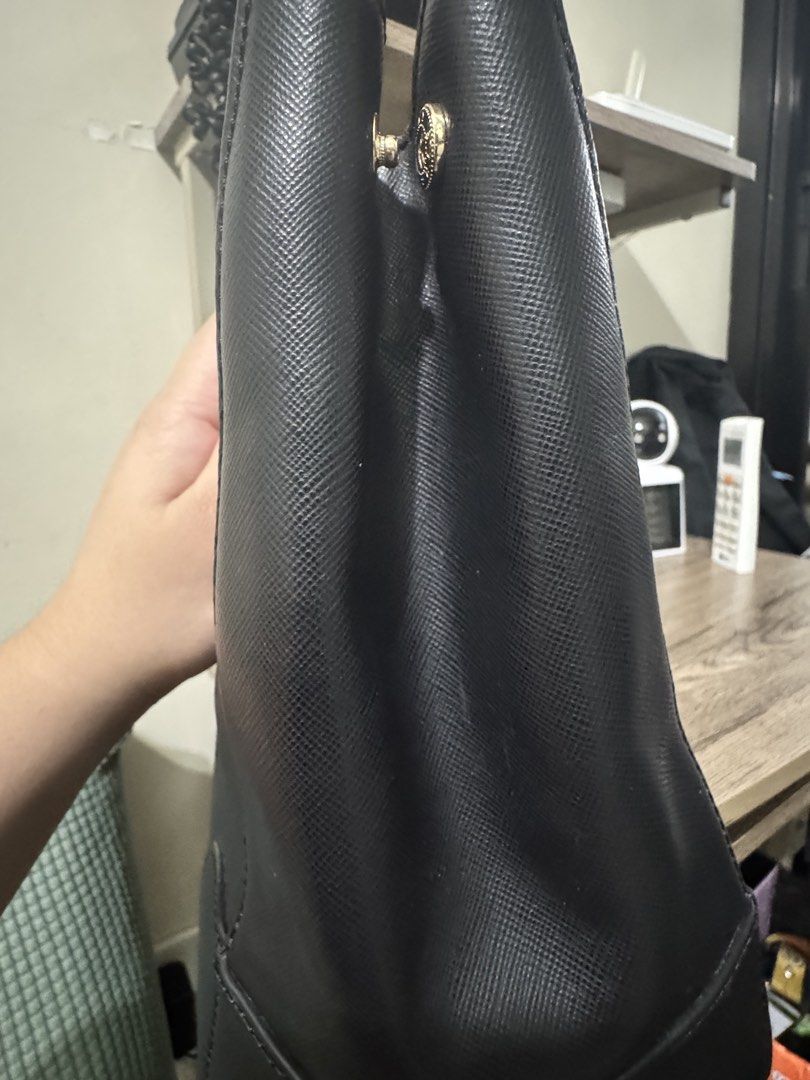 Tory Burch Black Satchel Bag (Category: Luxury Bags & Wallets) located in Quezon City. Submitted by mslen08 (Listing ID 1430184517, Image 3). Description: Black satchel bag by Tory Burch. Features a top zipper closure, gold-tone hardware, and dual top handles. Includes a detachable tag and a spacious interior with a zippered pocket and a logo emblem. The bag has a structured design with a textured finish. The interior lining is blue. Authentic wi