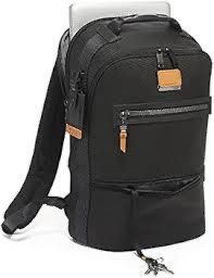 Tumi Essentials Backpack (Category: Backpacks) located in Manila. Submitted by everythingauthentic2016 (Listing ID 1430048752, Image 2). Description: Black Tumi backpack with multiple compartments. Features a top handle, adjustable shoulder straps, and a front zippered pocket. Includes a luggage tag and a bottom compartment. Suitable for carrying a laptop and other essentials. The backpack has a sleek, modern design..