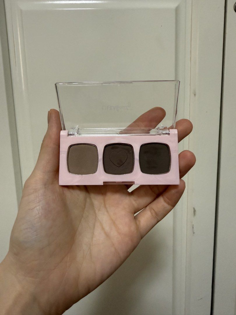 Ulta Beauty Brow Palette (Category: Makeup) located in Manila. Submitted by maag16 (Listing ID 1430077189, Image 2). Description: Ulta Beauty brow palette features three shades: light, medium, and dark. The palette includes a clear lid and a pink base. The back of the palette indicates it contains 3 x 1.2g brow powders. The batch code is 38205-08..