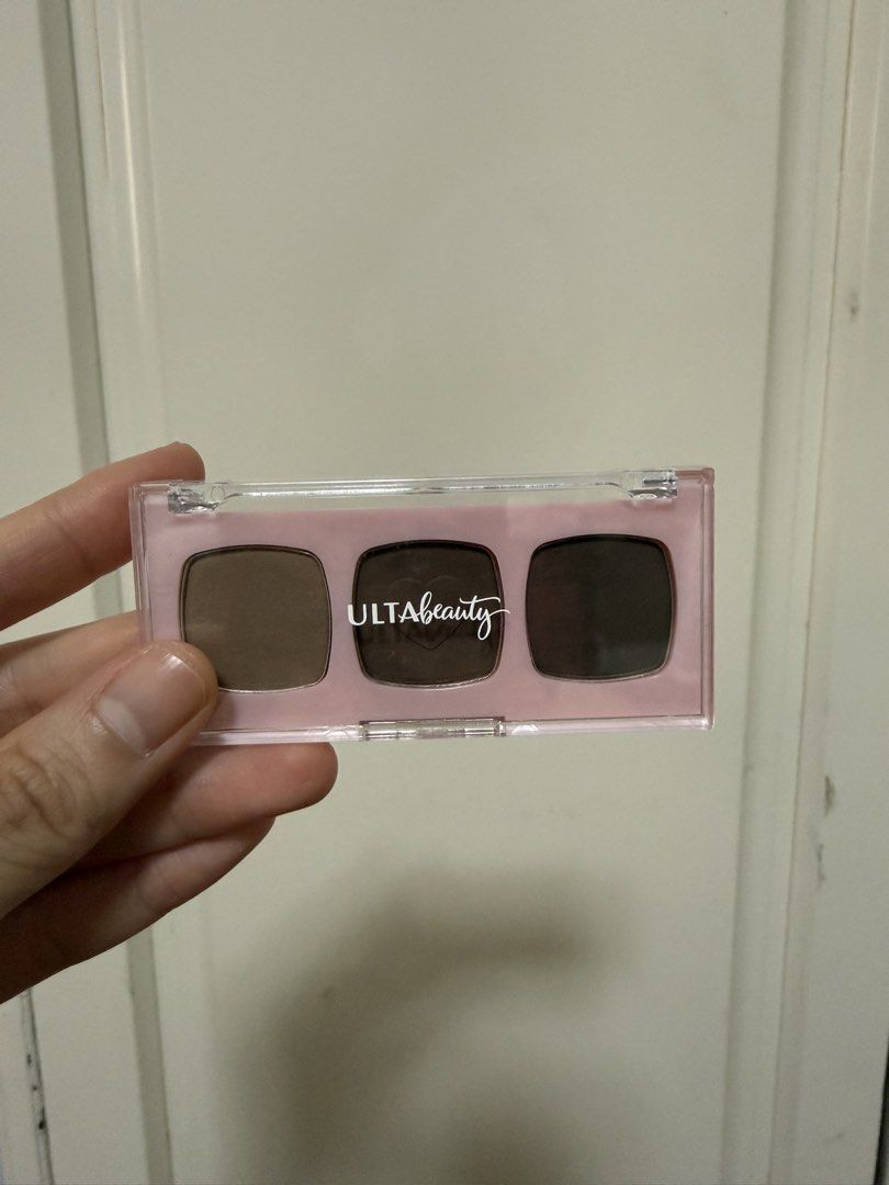 Ulta Beauty Brow Palette (Category: Makeup) located in Manila. Submitted by maag16 (Listing ID 1430077189, Image 1). Description: Ulta Beauty brow palette features three shades: light, medium, and dark. The palette includes a clear lid and a pink base. The back of the palette indicates it contains 3 x 1.2g brow powders. The batch code is 38205-08..