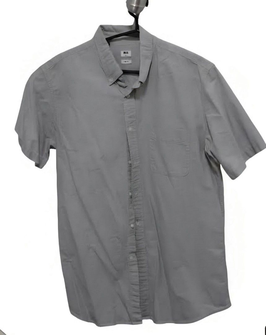 Uniqlo Short Sleeve Button-Down Shirt grey (Category: Tshirts & Polo Shirts ) located in Manila. Submitted by aclosetsale (Listing ID 1430143012, Image 1). Description: Gray short-sleeved button-down shirt from Uniqlo. Features a button-down collar and a single chest pocket. The shirt has a classic, versatile design suitable for various occasions..