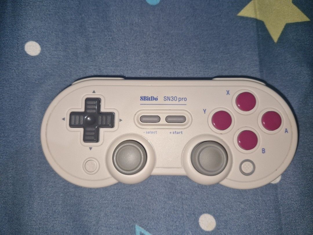 8BitDo SN30 Pro Game Controller (Category: Controllers) located in Pasig City. Submitted by rainbowbright8 (Listing ID 1430316175, Image 3). Description: 8BitDo SN30 Pro is a versatile game controller compatible with Switch, Apple, Windows, Steam, Android, and Raspberry Pi. It features a classic design with a D-pad, two analog sticks, and action buttons. The controller connects via Bluetooth. The model is SN30 Pro..