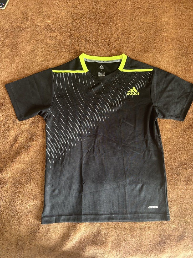 Adidas Black Training T-Shirt - Size M (Category: Activewear) located in Quezon City. Submitted by donbuys (Listing ID 1430259055, Image 2). Description: Adidas training t-shirt in black with neon green accents. Features a unique pattern on the front. Made in Vietnam. Size M. Measurements: 24 inches in length, 18 inches across the chest. Includes ClimaLite technology. Perfect for workouts or casual wear..