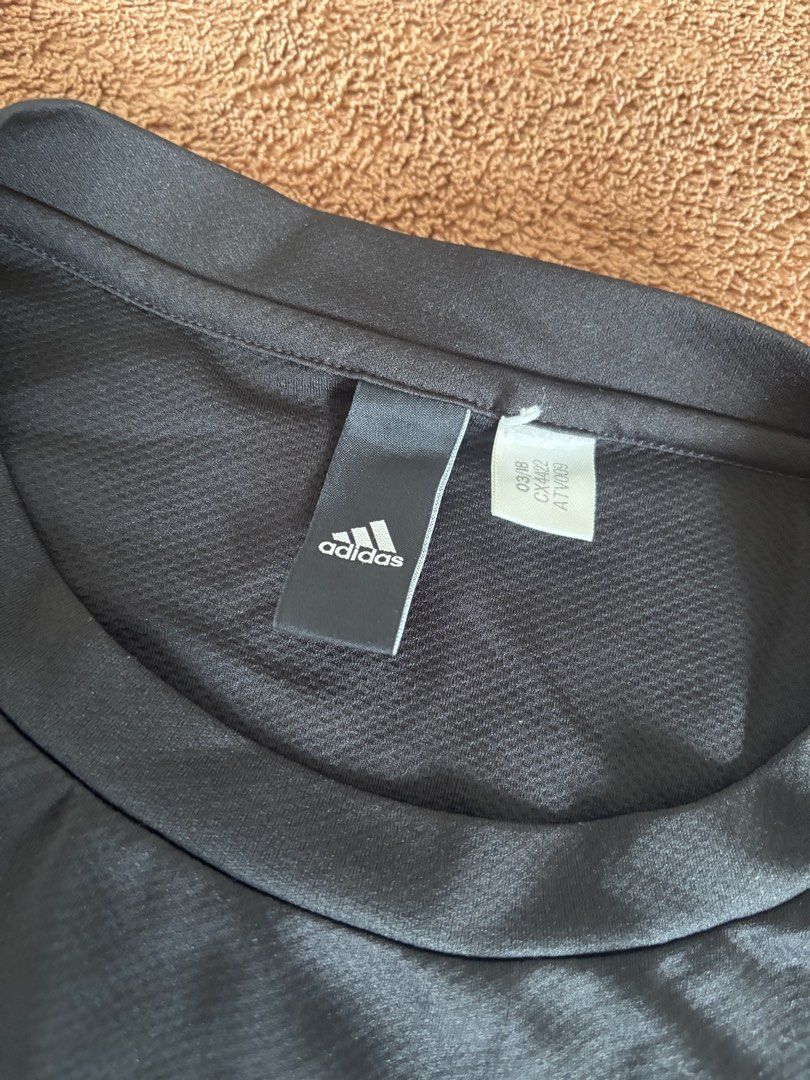 Adidas Climalite Black T-Shirt (Category: Activewear) located in Quezon City. Submitted by donbuys (Listing ID 1430259342, Image 2). Description: Black Adidas Climalite t-shirt. Features a crew neck and short sleeves. The Adidas logo is visible on the chest. The shirt has a textured fabric. Measurements: approximately 18 inches across the chest and 25 inches in length..