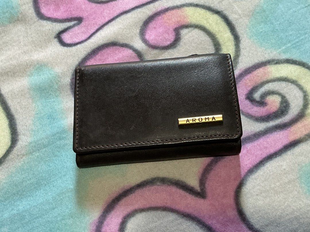 Aroma Genuine Leather Key Holder (Category: Wallets & Card holders) located in Angeles City. Submitted by goodbuysathome (Listing ID 1430265627, Image 1). Description: Aroma key holder is made of genuine leather. It features a key ring, a coin compartment, and a snap closure. The key holder is brown in color and has the Aroma logo on the front. It is a compact and stylish accessory for organizing your keys and small essentials. Add sf 55 gcash pa